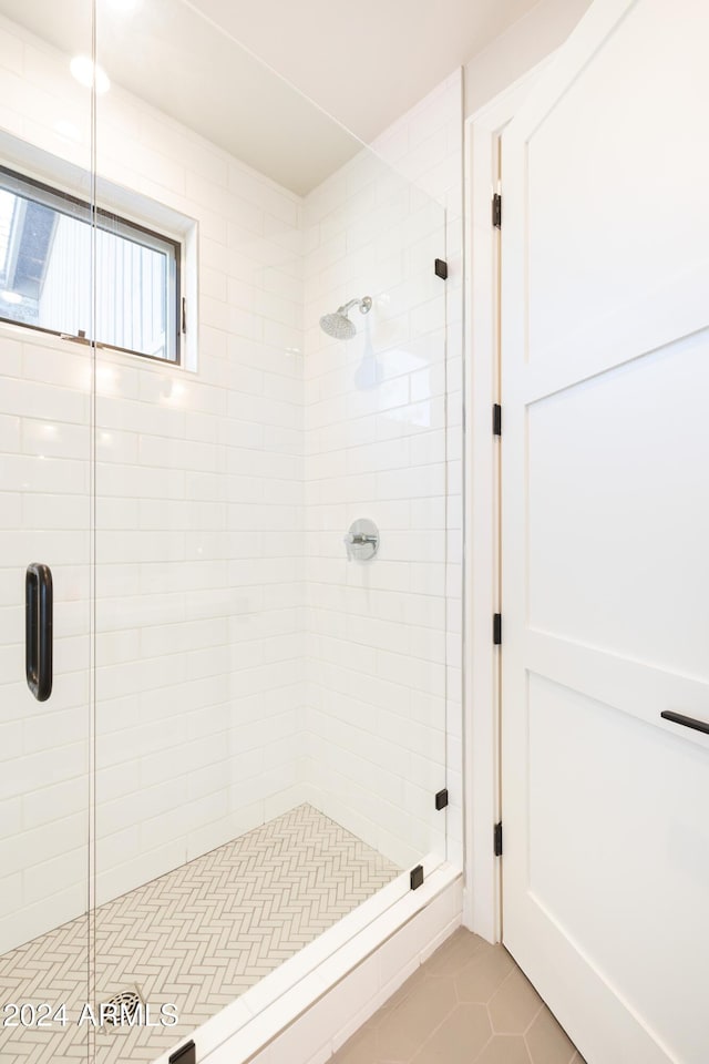 bathroom with tile patterned flooring and walk in shower