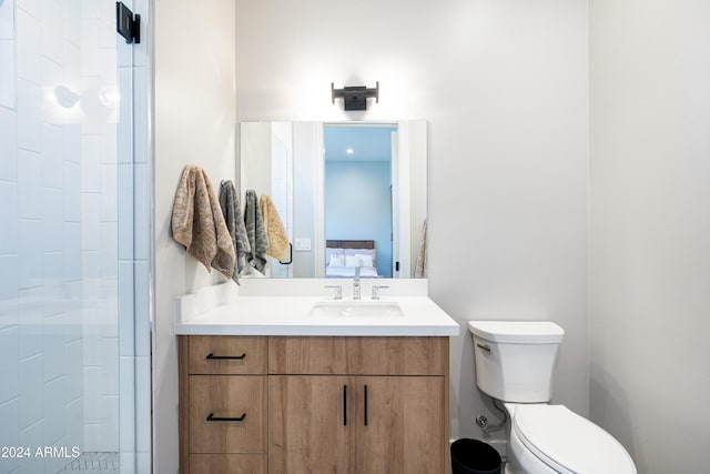 bathroom featuring vanity, toilet, and a shower with door