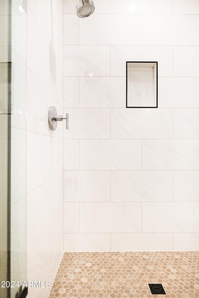 bathroom with a tile shower