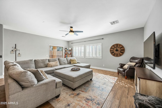 living room featuring hardwood / wood-style floors and ceiling fan