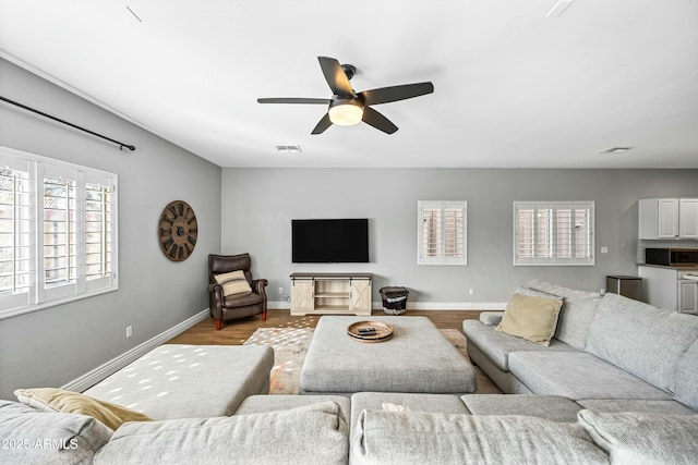 living room featuring light hardwood / wood-style flooring and ceiling fan