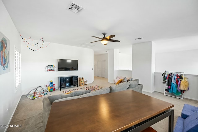 living room with light colored carpet and ceiling fan