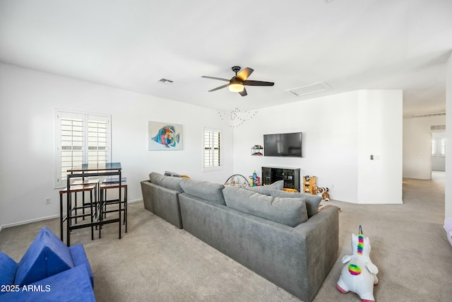 living room featuring ceiling fan and light colored carpet