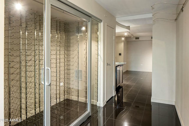 corridor with dark tile patterned floors