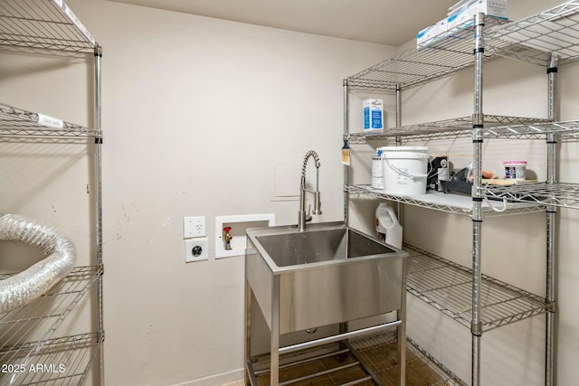 clothes washing area with electric dryer hookup, hookup for a washing machine, and sink