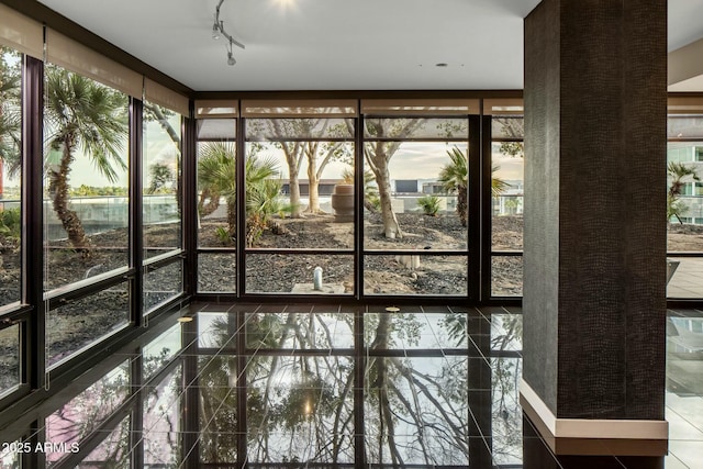 unfurnished sunroom featuring a water view