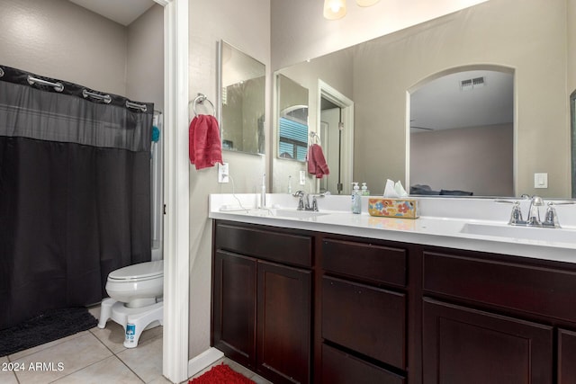 bathroom featuring vanity, a shower with curtain, tile patterned floors, and toilet