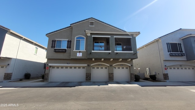 view of front of house with a garage and a balcony