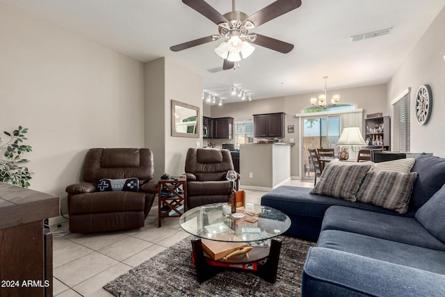 tiled living room featuring ceiling fan with notable chandelier and track lighting