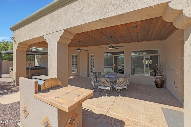 view of patio / terrace with ceiling fan and area for grilling