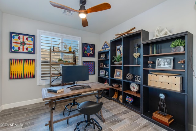 office space with visible vents, baseboards, ceiling fan, and wood tiled floor