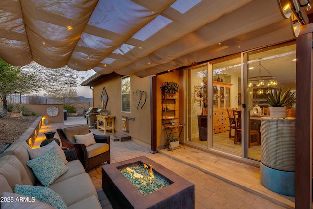 view of patio featuring an outdoor living space with a fire pit, a pergola, and a grill