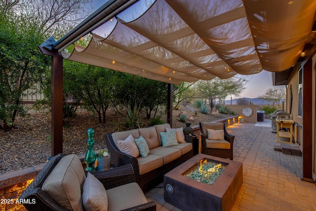 view of patio with a pergola and an outdoor living space with a fire pit