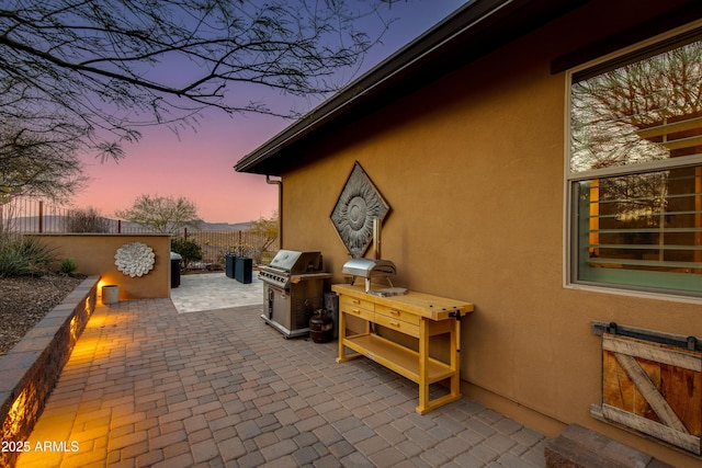 view of patio with a grill and fence