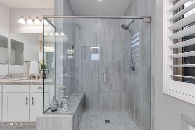 full bathroom with vanity and a stall shower