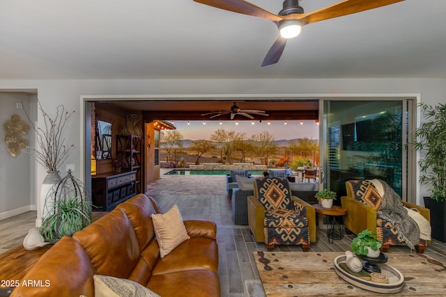 living room with wood finished floors and a ceiling fan