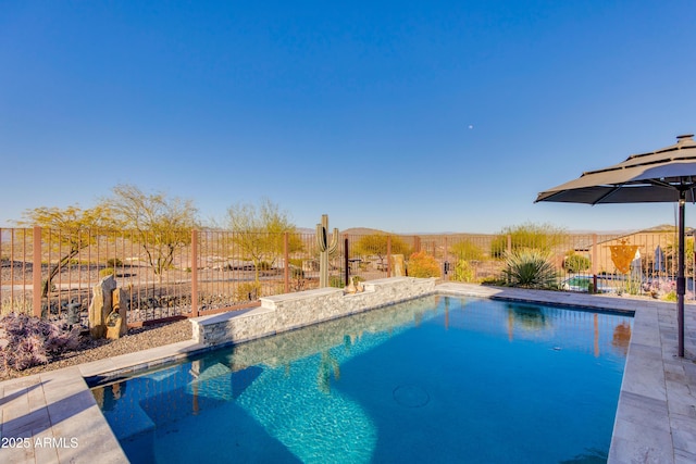 view of swimming pool featuring a fenced in pool and fence