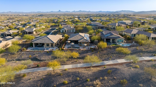 birds eye view of property with a mountain view and a residential view