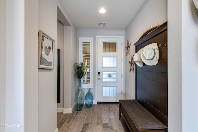 mudroom with light wood-style flooring, baseboards, and visible vents