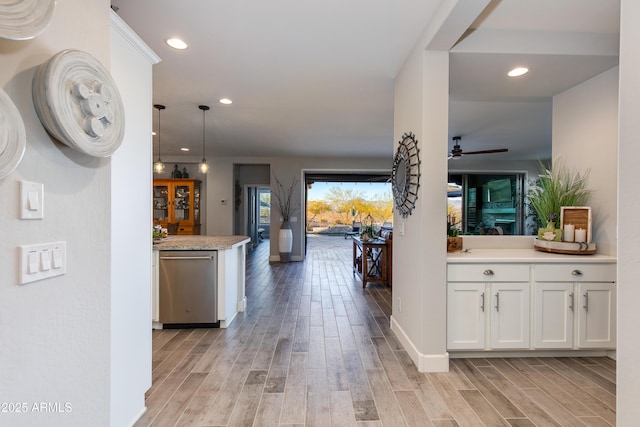 hall featuring recessed lighting, light wood-style flooring, and baseboards