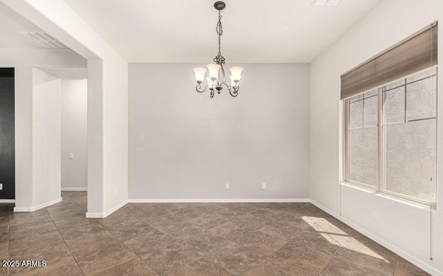 empty room with an inviting chandelier