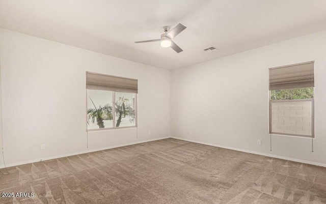 spare room with ceiling fan and carpet