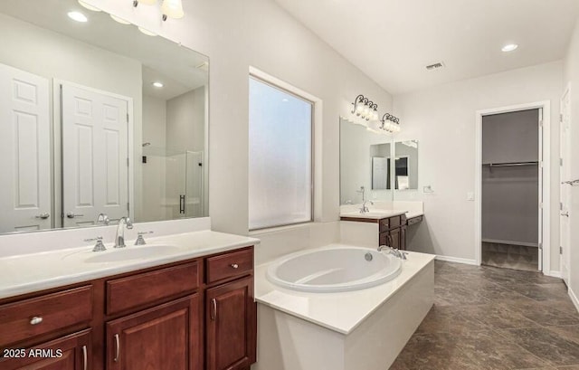 bathroom featuring shower with separate bathtub and vanity