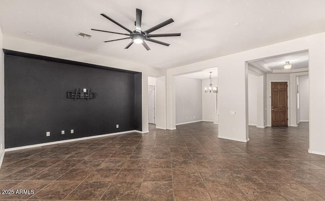 unfurnished living room with ceiling fan with notable chandelier