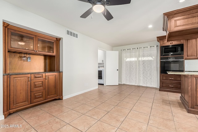 kitchen with visible vents, glass insert cabinets, light tile patterned floors, black appliances, and a ceiling fan