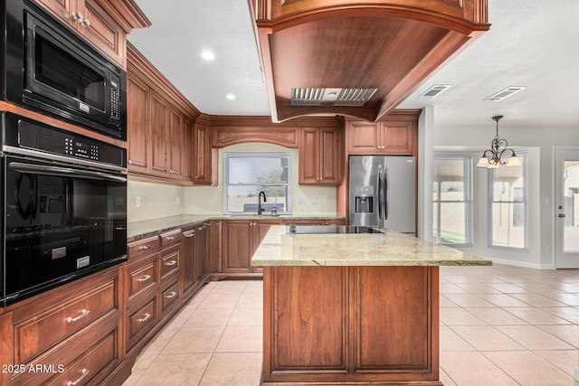 kitchen with visible vents, a center island, light tile patterned floors, light stone counters, and black appliances