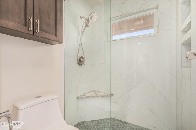 full bathroom featuring a marble finish shower and toilet