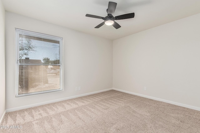 empty room with baseboards, a ceiling fan, and carpet flooring