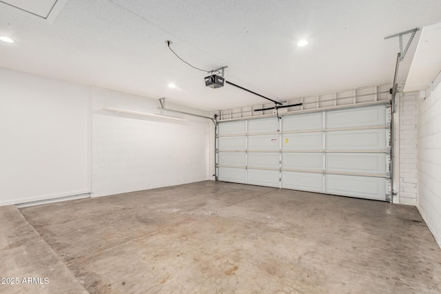 garage with recessed lighting and a garage door opener