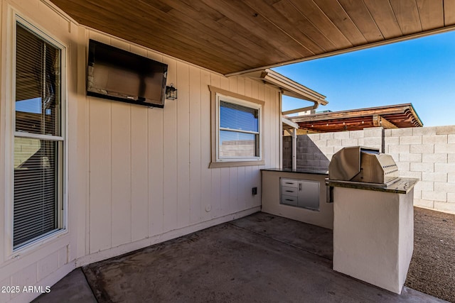 view of patio featuring area for grilling and fence