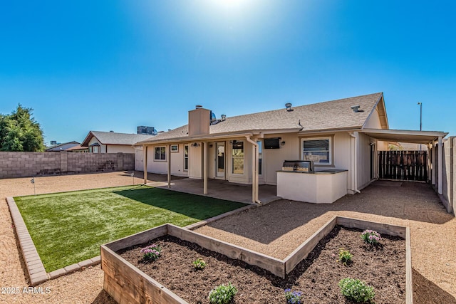 back of property with a garden, a yard, a patio, and a fenced backyard