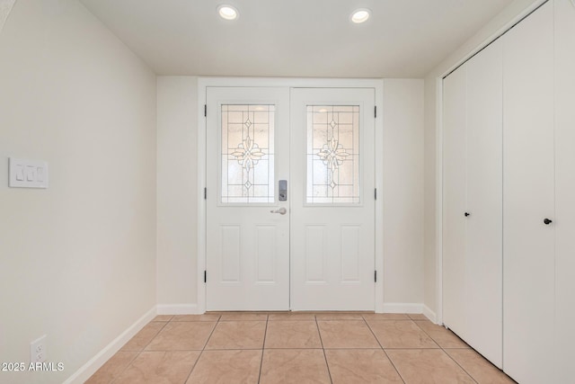 entrance foyer with light tile patterned flooring, recessed lighting, and baseboards