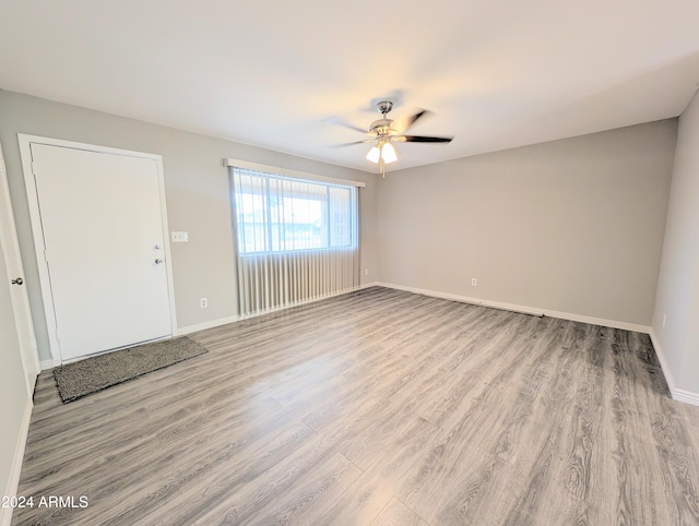 unfurnished living room featuring light hardwood / wood-style flooring and ceiling fan