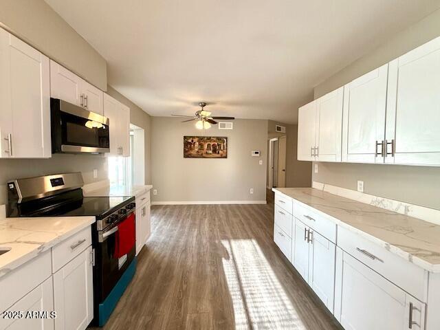 kitchen with stainless steel appliances, white cabinets, baseboards, a ceiling fan, and dark wood-type flooring