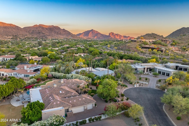 aerial view at dusk featuring a mountain view