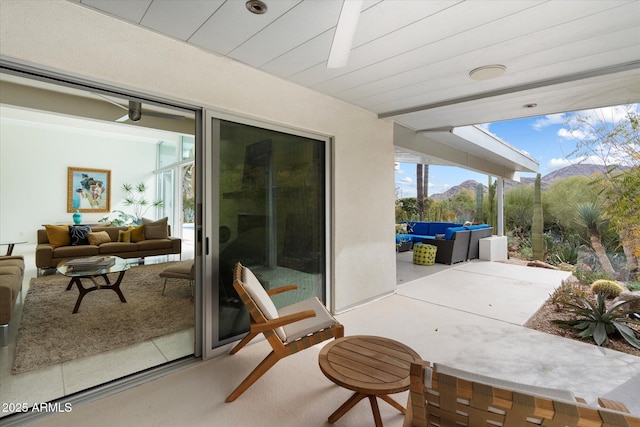 view of patio / terrace featuring an outdoor living space and a mountain view