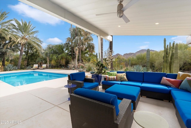 view of pool featuring ceiling fan, a mountain view, a patio area, and outdoor lounge area