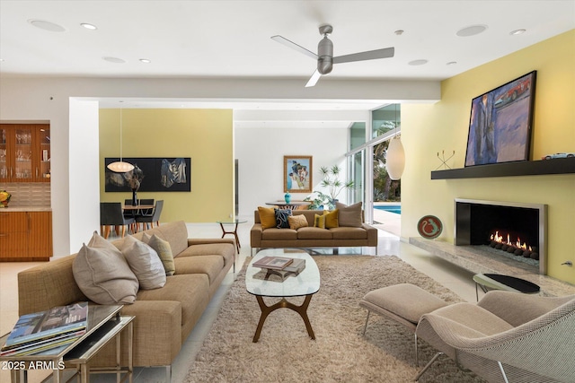 living room with expansive windows and ceiling fan