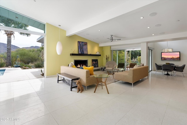 living room featuring a mountain view, vaulted ceiling with beams, and light tile patterned flooring