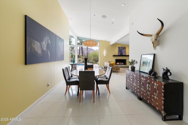 dining area featuring light tile patterned flooring and floor to ceiling windows