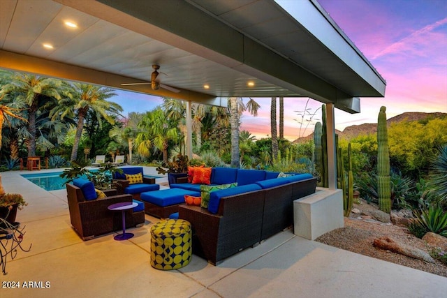 patio terrace at dusk with ceiling fan and outdoor lounge area