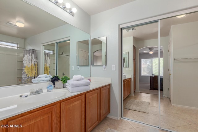 1142 E Mayfield Dr, San Tan Valley, AZ 85143 - bathroom with vanity, ceiling fan, a shower with shower curtain, tile patterned flooring, and baseboards