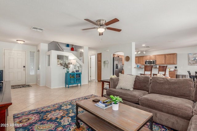 1142 E Mayfield Dr, San Tan Valley, AZ 85143 - living area with ceiling fan, light tile patterned floors, baseboards, and arched walkways