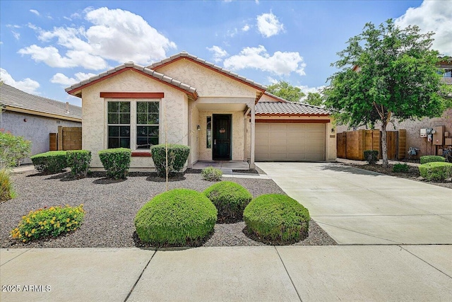 12775 W Lowden Rd, Peoria, AZ 85383 - view of front of house featuring an attached garage, concrete driveway, stucco siding, and a tile roof
