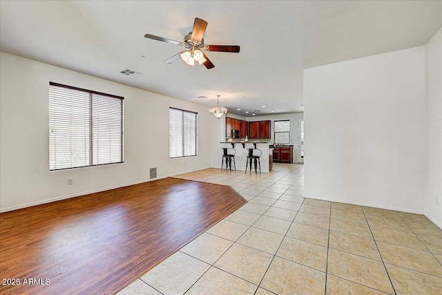 12775 W Lowden Rd, Peoria, AZ 85383 - unfurnished living room featuring a chandelier, ceiling fan, light tile patterned floors, baseboards, and recessed lighting