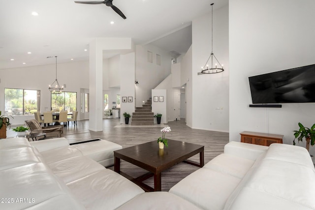 723 E Gemini Pl, Chandler, AZ 85249 - living room featuring a chandelier, high vaulted ceiling, ceiling fan, stairs, and recessed lighting